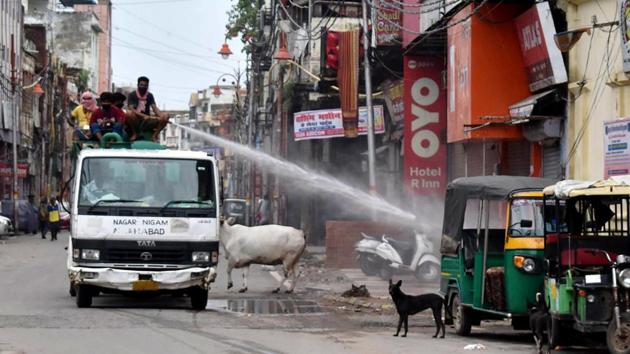 Municipal workers sanitize a market during the lockdown in an attempt to contain the spread of the coronavirus disease in Prayagraj on Sunday. (ANI Photo) (ANI File Photo) Municipal workers sanitize a market during the lockdown in an attempt to contain the spread of the coronavirus disease in Prayagraj on Sunday. (ANI Photo) (ANI File Photo)