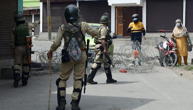 CRPF personnel stop people during strict lockdown reimposed due to rising cases of Covid-19, in Srinagar on Monday.(ANI photo)