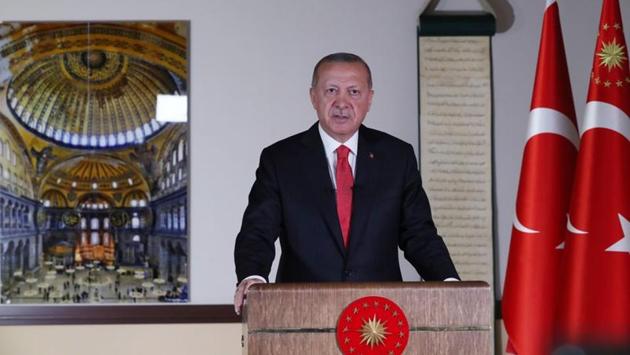 Turkish President Tayyip Erdogan with a picture of Hagia Sophia or Ayasofya in the background, delivers a televised address to the nation in Ankara on July 10. Erdogan in his address said the first prayers inside Hagia Sofia would be held on July 24, and urged respect for the decision. (Turkish Presidential Press Office via REUTERS)
