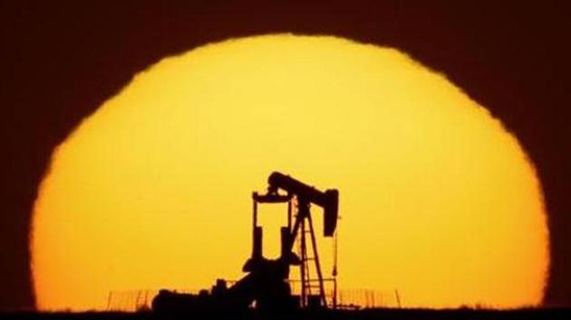 An idle oil pumping unit is silhouetted against the setting sun.(AP file photo)