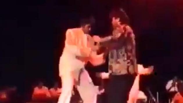 Anil Kapoor and Amitabh Bachchan perform in a stadium.