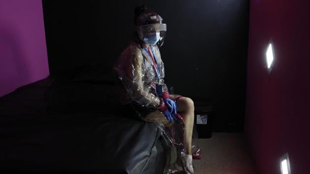 A sex worker wearing protective gear against the spread of the new coronavirus sits on a bed during a demonstration of the safety precautions they will take at their jobs in El Alto, Bolivia, Monday, June 29, 2020. Without kisses, with masks and with a transparent protective suit over their clothes, a group of Bolivian sex workers is trying to convince the authorities to allow them to return to their activities that were suspended by the COVID-19 pandemic. Although prostitution is not totally legal in Bolivia, local city governments regulate its practice within their jurisdictions. (AP) A sex worker wearing protective gear against the spread of the new coronavirus sits on a bed during a demonstration of the safety precautions they will take at their jobs in El Alto, Bolivia, Monday, June 29, 2020. Without kisses, with masks and with a transparent protective suit over their clothes, a group of Bolivian sex workers is trying to convince the authorities to allow them to return to their activities that were suspended by the COVID-19 pandemic. Although prostitution is not totally legal in Bolivia, local city governments regulate its practice within their jurisdictions. (AP)