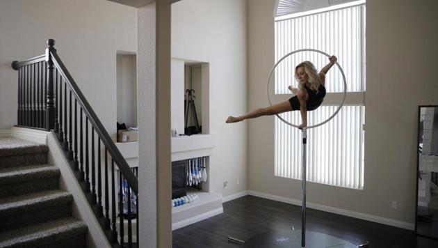 Melissa James, a dancer and aerialist in the show "Extravaganza" at Bally's casino resort, trains in her home Saturday, June 20, 2020, in Las Vegas. "I do something every day," said James about training while her show is closed due to the coronavirus.(AP)