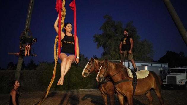 From left, Nicole England-Czyzewski, Alethea Shelton and Erik Martonovich practice a routine for "Gladius The Show," a touring equestrian and acrobatic show, Thursday, May 28, 2020, in Las Vegas. The performers train at night in the summer to avoid high temperatures during the day. (AP)