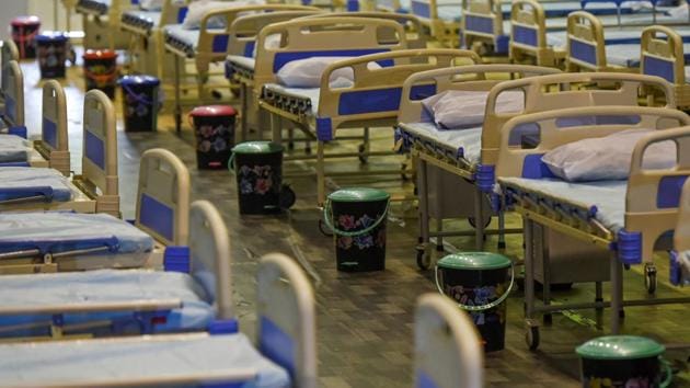 Empty beds with trash bins next to them for patients at the Commonwealth Games Village Covid-19 care centre in New Delhi on July 12. Gauging the favourable conditions and easy availability of beds, the government has put on hold a plan to convert stadiums such as Talkatora and Pragati Maidan into makeshift hospitals, reported HT.  (Biplov Bhuyan / HT Photo) 