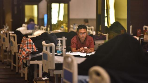 A Covid-19 patient uses his phone at the temporary covid care facility at Shehnai Banquet on July 13. Delhi’s recovery rate breached the 50% mark on June 20, after hovering below it for almost a month. This came on the back of a spike from 44.37% on June 19 to 55.14% the next day. (Sanchit Khanna / HT Photo)