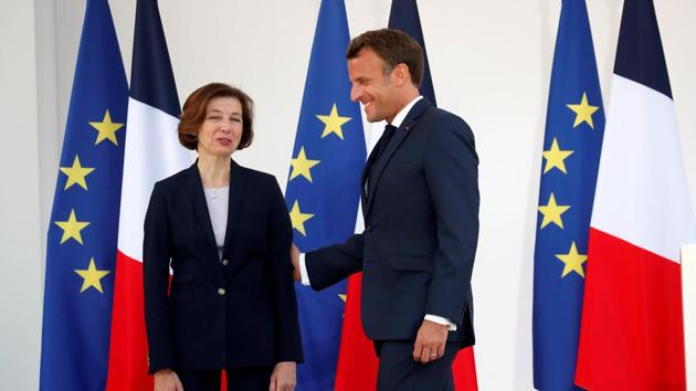 French President Emmanuel Macron talks to French Defence Minister Florence Parly after giving a speech to the French Military Forces at the Hotel de Brienne in Paris, France, July 13, 2020. (REUTERS/Gonzalo Fuentes)