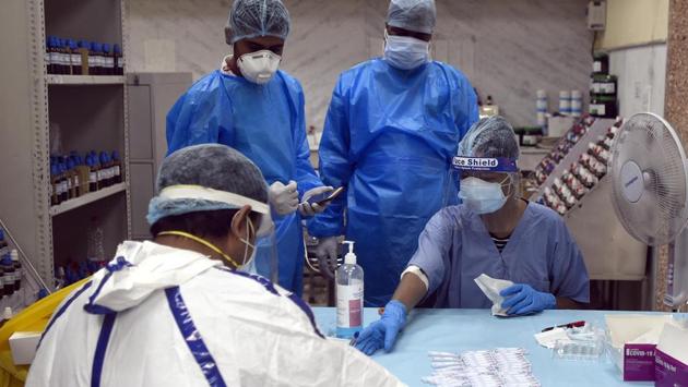 Health workers in protective equipment work on testing Covid-19 samples collected from people, at Nehru Homoeopathic Medical College and Hospital in New Delhi on July 11. Overall, 91,312 recoveries have taken place till the day ending July 13, while the total number of cases in Delhi stands at 113,740. (Sonu Mehta / HT Photo)