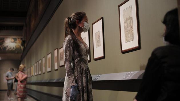 Visitors wearing a face mask to protect against coronavirus, looks at the exhibition From Durer to Matisse Selected drawings. (AP PHOTO/Alexander Zemlianichenko Jr) Visitors wearing a face mask to protect against coronavirus, looks at the exhibition From Durer to Matisse Selected drawings. (AP PHOTO/Alexander Zemlianichenko Jr)