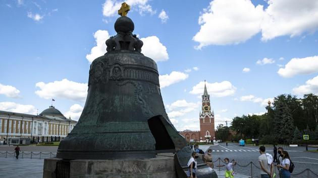 People walk around the Tsar Bell in the Kremlin in Moscow, Russia, with the Spasskaya Tower, right, and Senate, left, in the background, Friday, July 10, 2020. (AP) People walk around the Tsar Bell in the Kremlin in Moscow, Russia, with the Spasskaya Tower, right, and Senate, left, in the background, Friday, July 10, 2020. (AP)