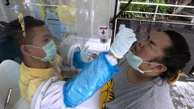 A health worker collects a nasal swab from a woman to test for coronavirus in Rayong province , Thailand, Tuesday, July 14, 2020. (AP Photo/Sakchai Lalit) A health worker collects a nasal swab from a woman to test for coronavirus in Rayong province , Thailand, Tuesday, July 14, 2020. (AP Photo/Sakchai Lalit)