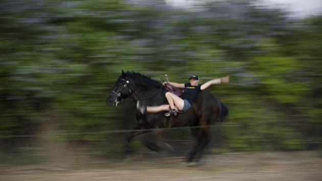 Ariel Hold practices a routine on a horse for "Gladius The Show," a touring equestrian and acrobatic show, Thursday, May 28, 2020, in Las Vegas. The coronavirus forced the producers to cancel all of their performances through 2020. (AP)