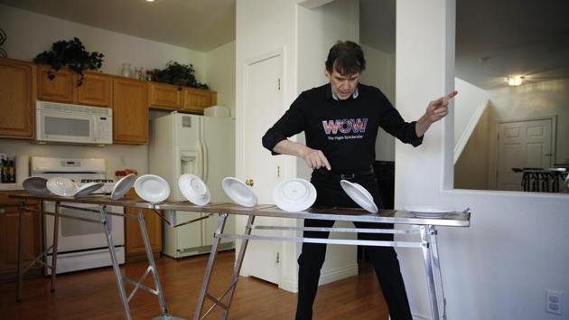 Juggler Victor Ponce practices his spinning plates routine in the kitchen of his home Friday, June 19, 2020, in Las Vegas. Ponce has continued to practice at home while the show he is in, "WOW - The Vegas Spectacular" is closed due to the coronavirus. (AP)