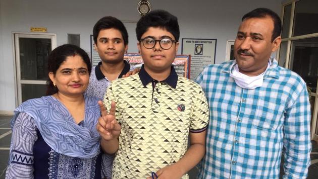 Mohali district first position holder Siddhant Rawat celebrates his success with parents on Wednesday. (HT Photo) Mohali district first position holder Siddhant Rawat celebrates his success with parents on Wednesday. (HT Photo)