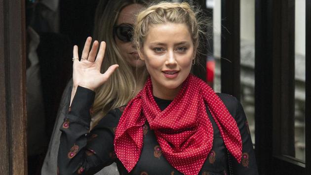 Amber Heard gestures as she arrives at the High Court for a hearing in Johnny Depp's libel case, in London.(AP)