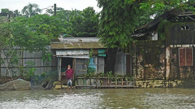 A man stands in front of his flooded house in Sunamgong on July 15. Flood like situations and the additional threats from landslides are simultaneously prevailing in large parts of India’s eastern and northeastern states along with Nepal and swathes of China’s southern provinces. (Munir uz Zaman / AFP) 