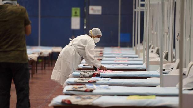 A medic prepares a bed inside the CWG Covid-19 care centre during Unlock 2.0 near Akshardham in New Delhi.(PTI File Photo)