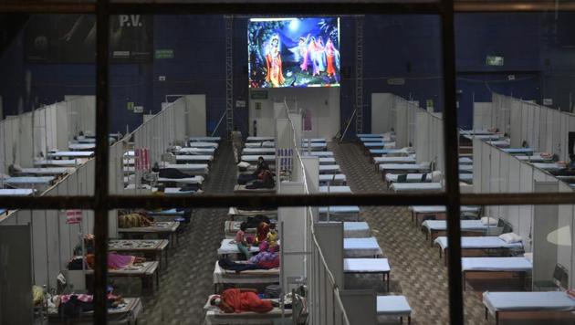 A view inside the CWG Stadium Covid Care Centre as patients watch a mythological programme on the screen in New Delhi on Wednesday. (Vipin Kumar/HT Photo) A view inside the CWG Stadium Covid Care Centre as patients watch a mythological programme on the screen in New Delhi on Wednesday. (Vipin Kumar/HT Photo)