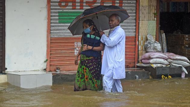 An elderly couple wade through a flooded street during rain in Mumbai on July 15. Incessant rains and water logging marked the day on July 15 across Mumbai and its suburbs, with traffic thrown out of gear and daily routines brought to a crawl. (Punit Paranjpe / AFP) An elderly couple wade through a flooded street during rain in Mumbai on July 15. Incessant rains and water logging marked the day on July 15 across Mumbai and its suburbs, with traffic thrown out of gear and daily routines brought to a crawl. (Punit Paranjpe / AFP)