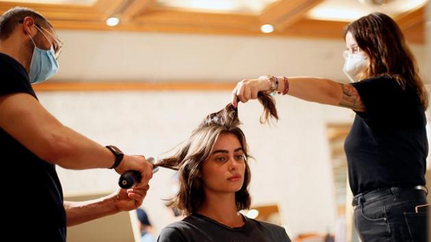 Model Taylor Hill has her hair done at the backstage of the Etro Spring/Summer 2021 Men's collection and Women's pre-collection in a livestreamed show at the Four Seasons hotel, amid the coronavirus disease (COVID-19) outbreak, during Milan Digital Fashion Week in Milan, Italy, July 15, 2020. (REUTERS)