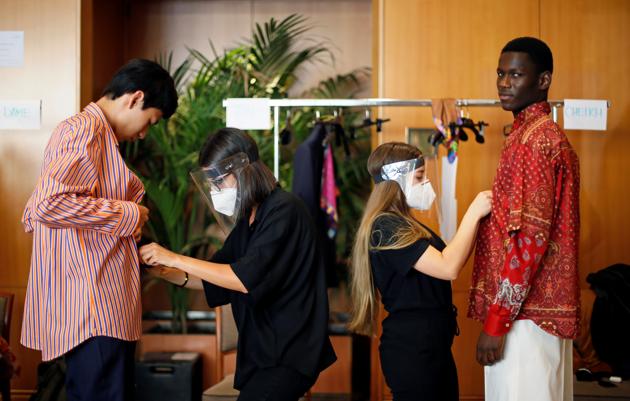Models and dressers are seen at the backstage of the Etro Spring/Summer 2021 Men's collection and Women's pre-collection livestreamed show at the Four Seasons hotel, amid the coronavirus disease (COVID-19) outbreak, during Milan Digital Fashion Week in Milan, Italy, July 15, 2020. (REUTERS)