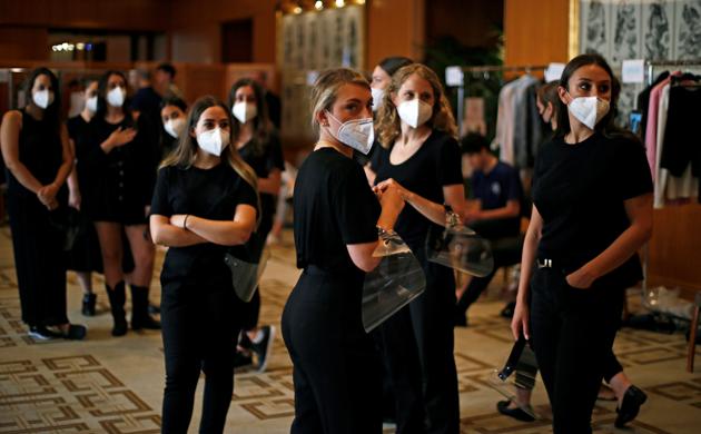 Dressers are pictured backstage before the Etro Spring/Summer 2021 Men's collection and Women's pre-collection in a livestreamed show at the Four Seasons hotel, amid the coronavirus disease (COVID-19) outbreak, during Milan Digital Fashion Week in Milan, Italy, July 15, 2020. (REUTERS)