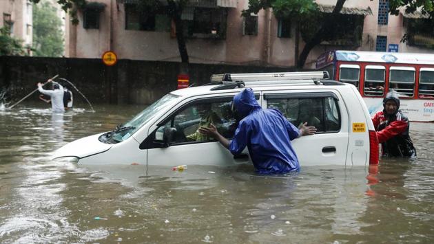 People push a car through a waterlogged street after it broke down in heavy rainfall in Mumbai on July 15. The IMD bulletin added that the rains could also lead to disruption in electricity and water supply, local traffic and road transport. (Francis Mascarenhas / REUTERS) People push a car through a waterlogged street after it broke down in heavy rainfall in Mumbai on July 15. The IMD bulletin added that the rains could also lead to disruption in electricity and water supply, local traffic and road transport. (Francis Mascarenhas / REUTERS)
