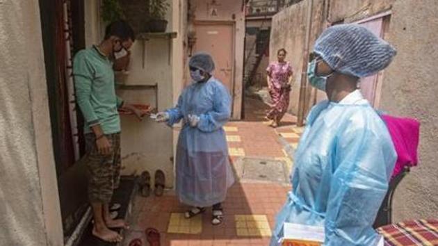 Health workers during a door to door screening for coronavirus in a slum near Dandekar bridge in Pune. (Pratham Gokhale/HT Photo) Health workers during a door to door screening for coronavirus in a slum near Dandekar bridge in Pune. (Pratham Gokhale/HT Photo)
