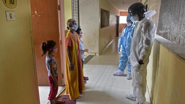 A health care staff wearing thermal scanning headgear screens residents in Malad on July 13. BMC’s data on age group and fatalities coincides with medical opinion that senior citizens are more susceptible to Covid-19 compared to other age groups because of already-weakened immunity. (Satyabrata Tripathy / HT Photo) A health care staff wearing thermal scanning headgear screens residents in Malad on July 13. BMC’s data on age group and fatalities coincides with medical opinion that senior citizens are more susceptible to Covid-19 compared to other age groups because of already-weakened immunity. (Satyabrata Tripathy / HT Photo)