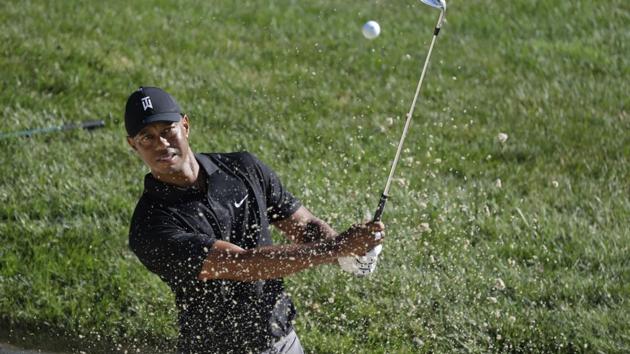 Dublin : Tiger Woods hits out of a bunker on the 15th hole during a practice round for the Memorial golf tournament.(AP)