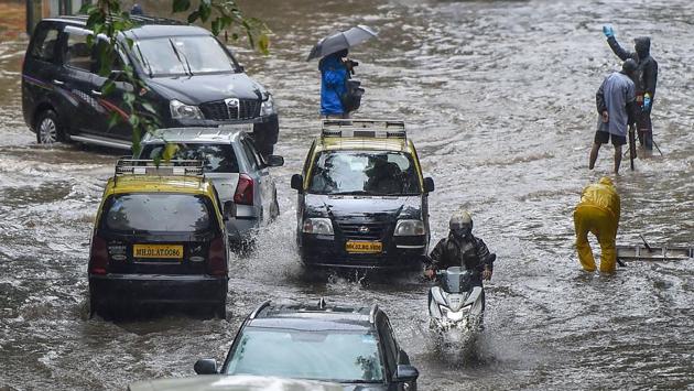 Vehicles ply along a water logged road at Dadar in Mumbai on July 15. The India Meteorological Department (IMD) had forewarned coastal Mumbai, Thane, and Palghar districts on July 14 with an orange alert, signalling chances for intense rainfall. (Kunal Patil / PTI) Vehicles ply along a water logged road at Dadar in Mumbai on July 15. The India Meteorological Department (IMD) had forewarned coastal Mumbai, Thane, and Palghar districts on July 14 with an orange alert, signalling chances for intense rainfall. (Kunal Patil / PTI)