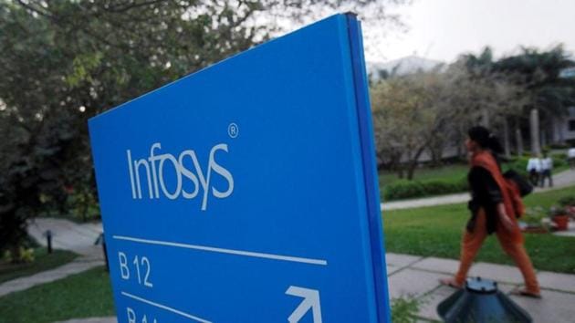 An employee walks past a signage board in the Infosys campus at the Electronics City IT district in Bangalore. (REUTERS) An employee walks past a signage board in the Infosys campus at the Electronics City IT district in Bangalore. (REUTERS)