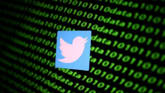 The Twitter logo and binary cyber codes are seen in this illustration.(REUTERS)