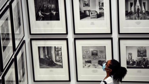 A visitor wearing a face mask views photographs in the exhibition Masculinities at the Barbican arts centre. (REUTERS/Toby Melville) A visitor wearing a face mask views photographs in the exhibition Masculinities at the Barbican arts centre. (REUTERS/Toby Melville)