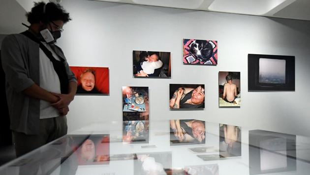 A visitor wearing a face mask views photographs in the exhibition 'Masculinities' at the Barbican arts centre, on the first day of its reopening. (REUTERS/Toby Melville) A visitor wearing a face mask views photographs in the exhibition 'Masculinities' at the Barbican arts centre, on the first day of its reopening. (REUTERS/Toby Melville)