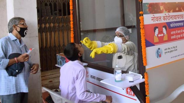 A medic collects a sample for Covid-19 testing during total lockdown at Gardiner Hospital in Patna, Bihar on Wednesday.(Santosh Kumar/HT Photo) A medic collects a sample for Covid-19 testing during total lockdown at Gardiner Hospital in Patna, Bihar on Wednesday.(Santosh Kumar/HT Photo)