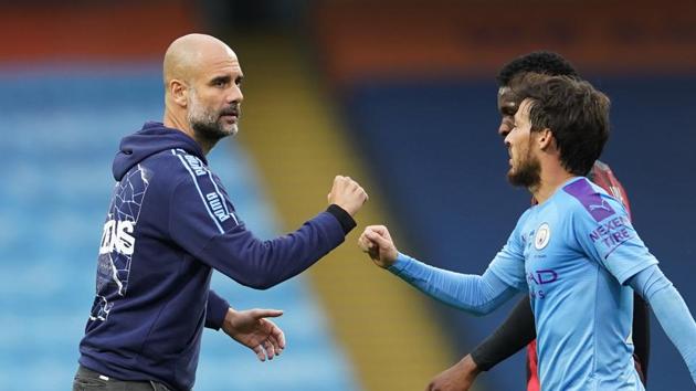 Manchester City manager Pep Guardiola shakes hands with David Silva after the match.(Pool via REUTERS)