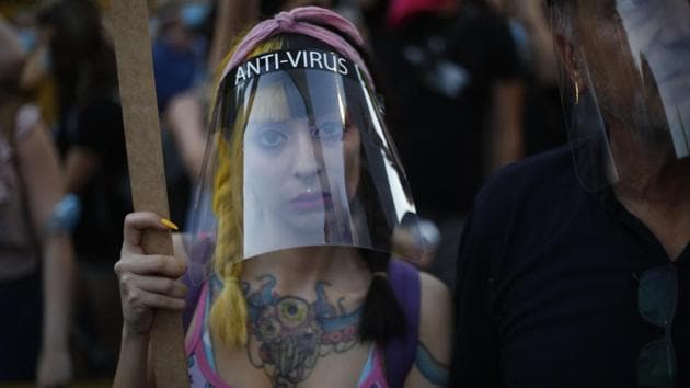 A protester wears a face shield as a precautionary measure against coronavirus outbreak, while attending the protest on July 14. Netanyahu initially won high marks both at home and abroad for assertive decisions that kept both virus deaths and infections down. But the reopening of the economy - done not in the gradual, measured way has brought cases shooting up again, reported Bloomberg. (Ariel Schalit / AP)