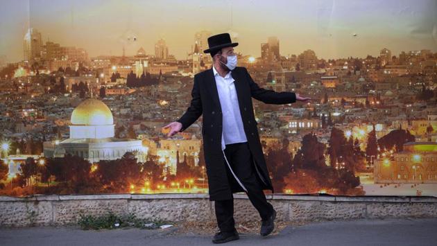 An Ultra-Orthodox Jewish man argues with a police officer (not in the frame) after being prevented to cross a street as lockdown takes place in Jerusalem on July 13. New lockdowns have been marked with protests by residents but officials have warned that if numbers don’t come down, Israel will have no choice but to lock the entire country down again, as it did till May. (Oded Balilty / AP) An Ultra-Orthodox Jewish man argues with a police officer (not in the frame) after being prevented to cross a street as lockdown takes place in Jerusalem on July 13. New lockdowns have been marked with protests by residents but officials have warned that if numbers don’t come down, Israel will have no choice but to lock the entire country down again, as it did till May. (Oded Balilty / AP)