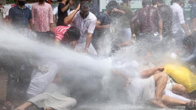 Police use water cannons to disperse a crowd gathered to demonstrate against the gold smuggling case, in Kozhikode on July 10.(PTI Photo)