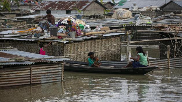 A flood affected family takes shelter on the roof of their partially submerged house along river Brahmaputra in Morigaon district, Assam on Thursday.(AP File Photo) A flood affected family takes shelter on the roof of their partially submerged house along river Brahmaputra in Morigaon district, Assam on Thursday.(AP File Photo)