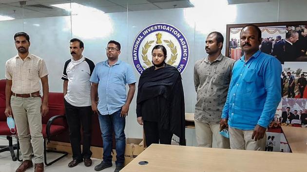 Kerala gold smuggling case accused Swapna Suresh and Sandeep Nair (both in middle) after they were arrested by the National Investigation Agency in Bengaluru. (PTI File) Kerala gold smuggling case accused Swapna Suresh and Sandeep Nair (both in middle) after they were arrested by the National Investigation Agency in Bengaluru. (PTI File)