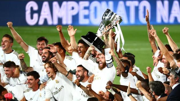 Real Madrid's Sergio Ramos and teammates celebrate with the trophy after winning La Liga.(REUTERS)