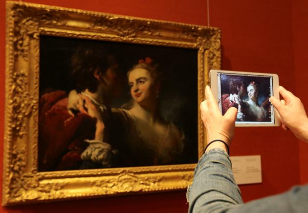 A visitor takes a picture of the painting "An Amorous Couple" by Pierre Louis Goudreaux at the Bohdan and Varvara Khanenko National Museum of Arts in Kyiv, Ukraine July 14, 2020. (REUTERS)