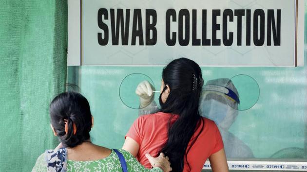 A young woman gives a swab sample for Covid-19 test at a collection centre, during strict lockdown imposed by Assam Government to curb the spread of novel coronavirus, in Guwahati. (PTI/For Representative Purposes Only) A young woman gives a swab sample for Covid-19 test at a collection centre, during strict lockdown imposed by Assam Government to curb the spread of novel coronavirus, in Guwahati. (PTI/For Representative Purposes Only)