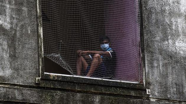 A patient wearing a facemask sits watching behind a net while recovering from the COVID-19 coronavirus at a care centre in Mumbai on July 16. A total of 690 new fatalities recorded on July 16 have now taken the disease death toll in the four-and-a-half months of the outbreak’s sweep across India to 25,594. (Punit Paranjpe / AFP) A patient wearing a facemask sits watching behind a net while recovering from the COVID-19 coronavirus at a care centre in Mumbai on July 16. A total of 690 new fatalities recorded on July 16 have now taken the disease death toll in the four-and-a-half months of the outbreak’s sweep across India to 25,594. (Punit Paranjpe / AFP)