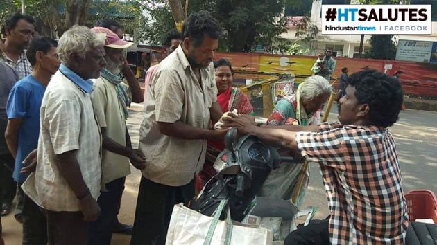 Three times a week, after winding up his fish trade for the day, Rao returns home on his Scooty to pick up food packets.(HT Photo)