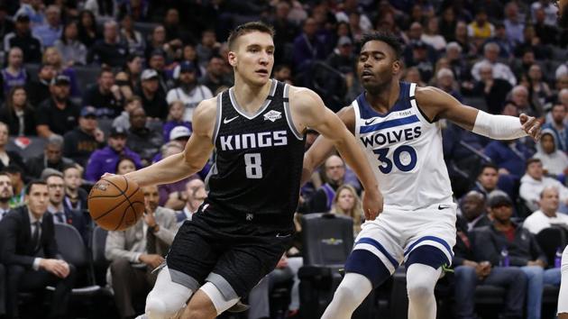 Sacramento Kings guard Bogdan Bogdanovic, left, drives to the basket against Minnesota Timberwolves forward Kelan Martin, right, during the second half of an NBA basketball game in Sacramento, Calif. (AP) Sacramento Kings guard Bogdan Bogdanovic, left, drives to the basket against Minnesota Timberwolves forward Kelan Martin, right, during the second half of an NBA basketball game in Sacramento, Calif. (AP)