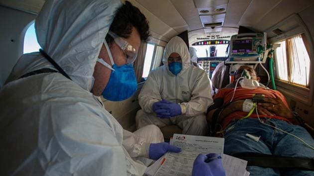 A COVID-19 positive patient receives medical care on a plane equipped as an ICU unit during the trip from the municipality of Almeirim to the city of Santarem in Para state, Brazil on July 15. A model created by professors from several Brazilian academic institutions, based on the number of confirmed deaths, estimates Brazil has had 10 million infections. (Tarso Sarraf / AFP)
