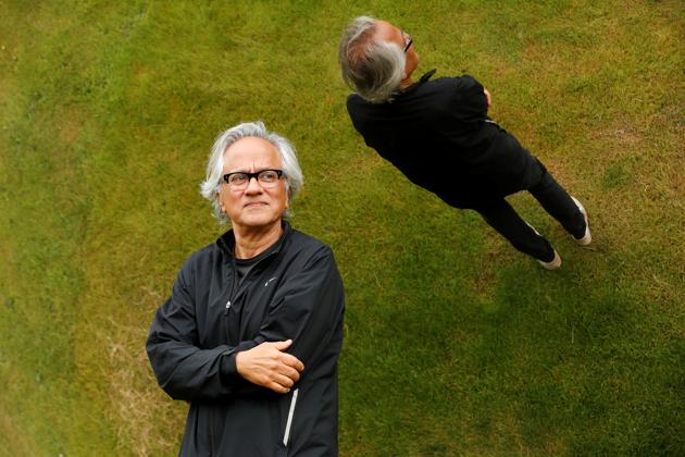 British-Indian artist Anish Kapoor is reflected in one of his sculptures as he poses in the gardens at Houghton Hall in Norfolk, Britain July 9, 2020. (REUTERS)